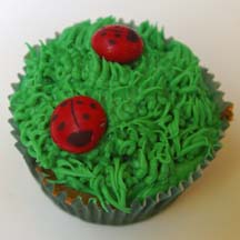 Ladybugs on grass cupcake